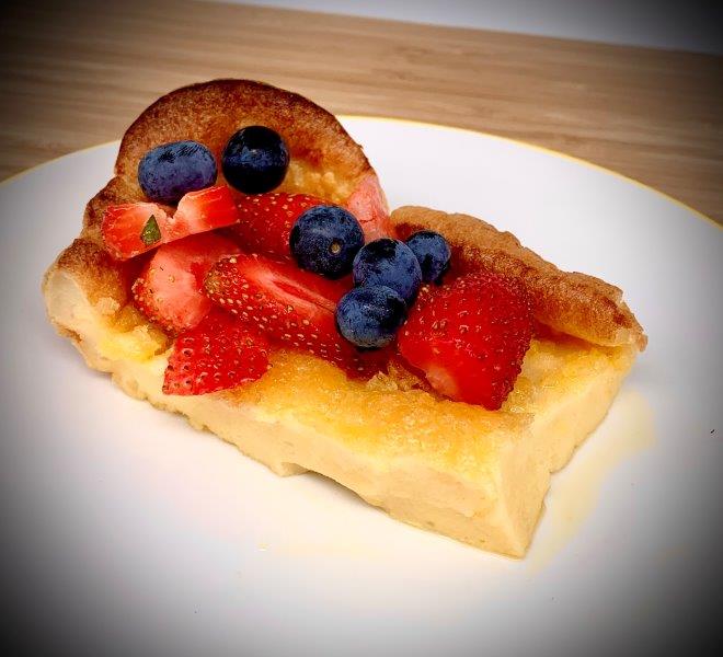 German Pancakes served with blueberries and strawberries